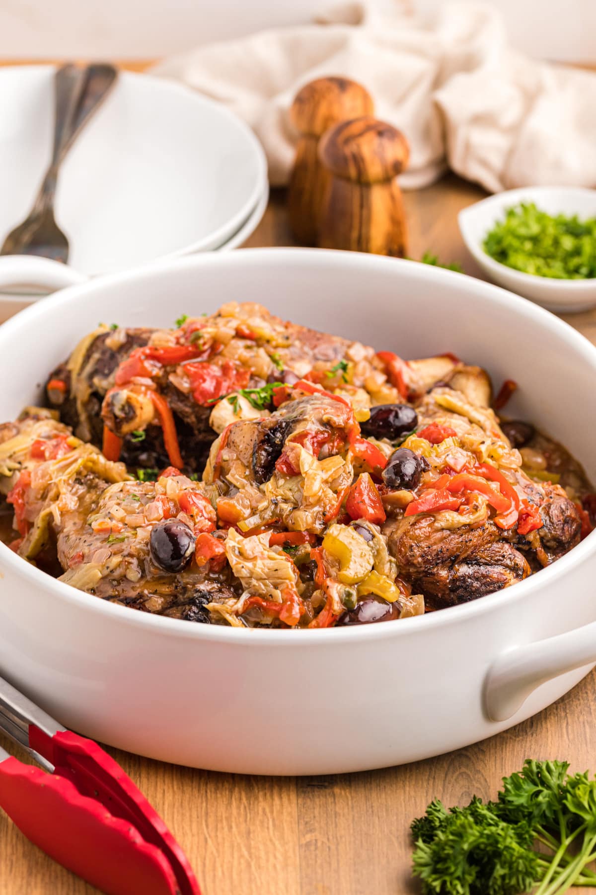 dish of lamb shanks topped with artichoke caponata