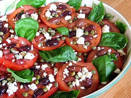 Tomato salad with basil and cheese in a dish