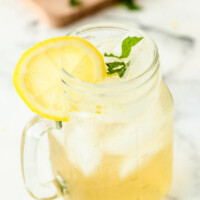vodka lemonade in a glass mug garnished with lemon