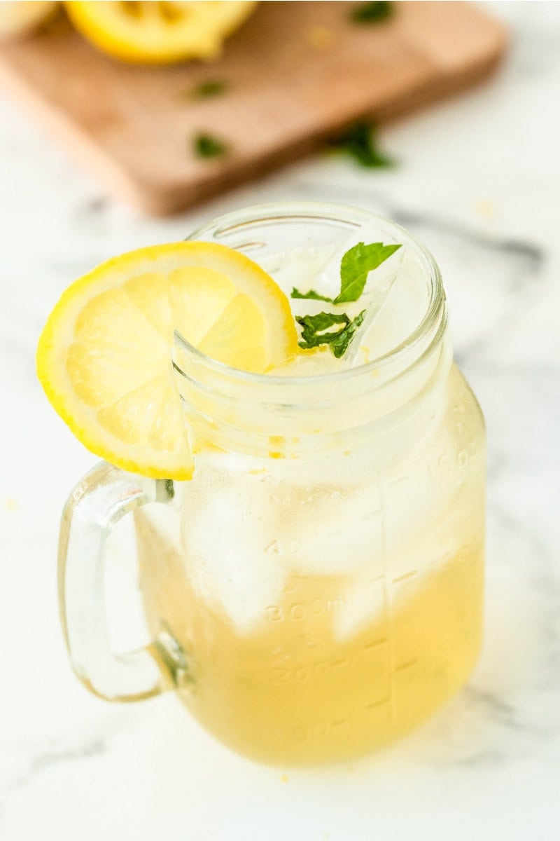 vodka lemonade in a glass mug garnished with lemon
