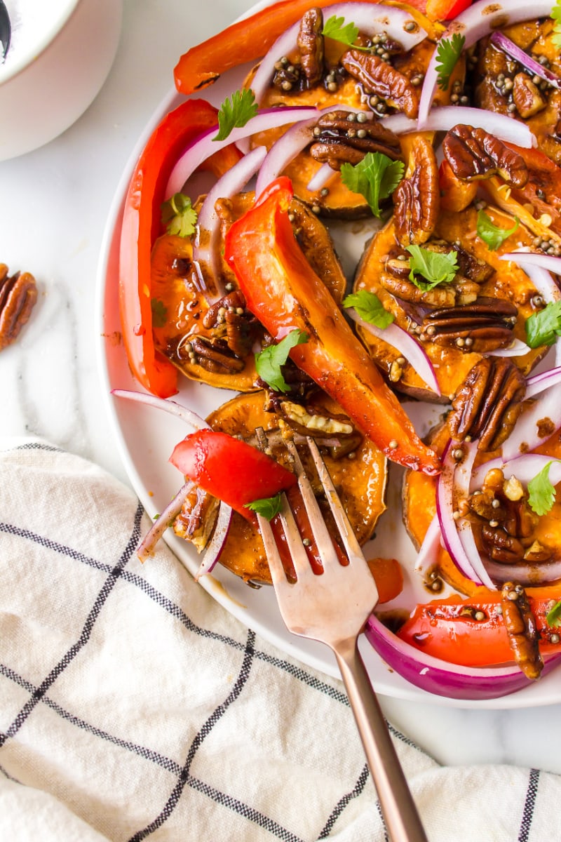 fork on a plate of yam and pecan salad