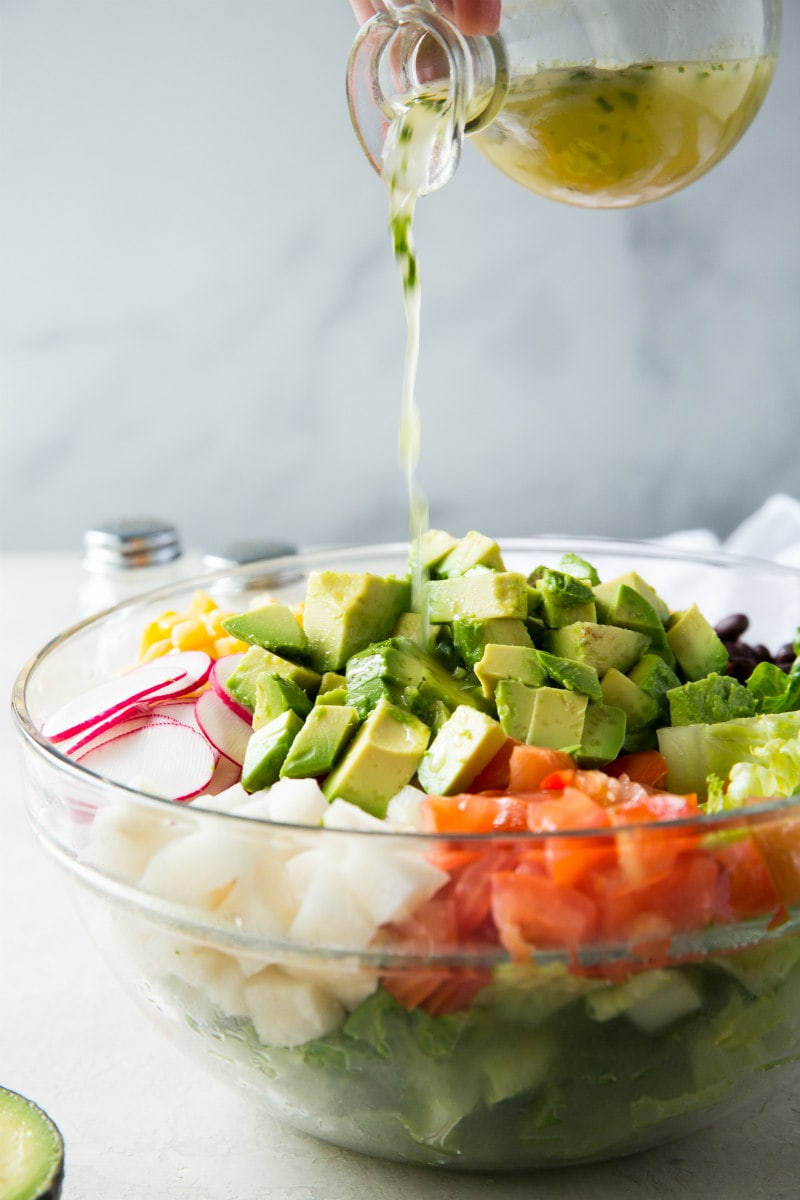 adding dressing to Mexican Chopped Salad