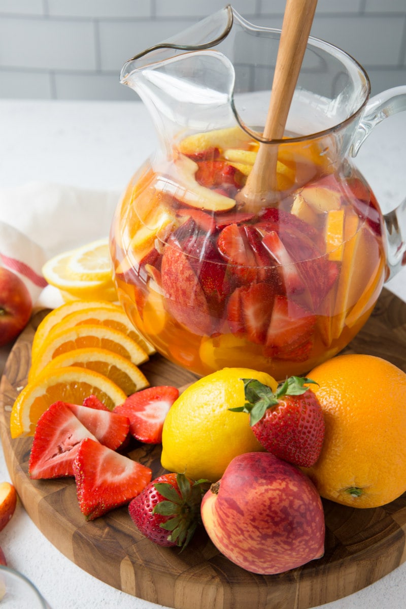 fruit platter with a pitcher of strawberry peach sangria