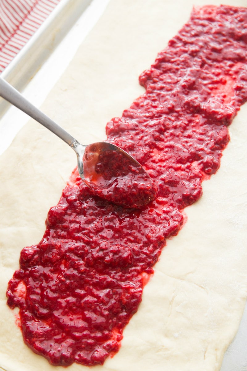adding the raspberry sauce to the dough for the candy cane coffee cake