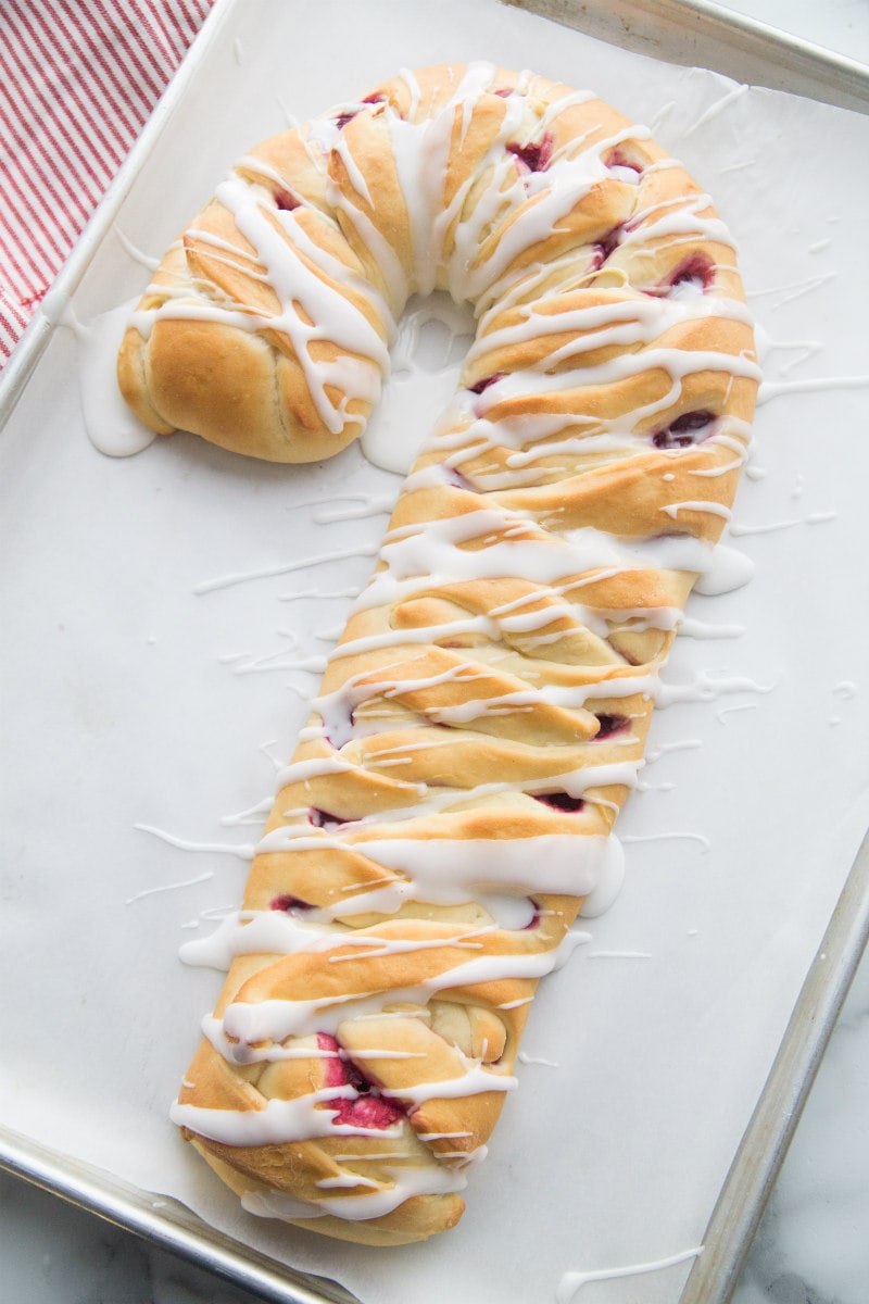 adding glaze to a candy cane coffee cake