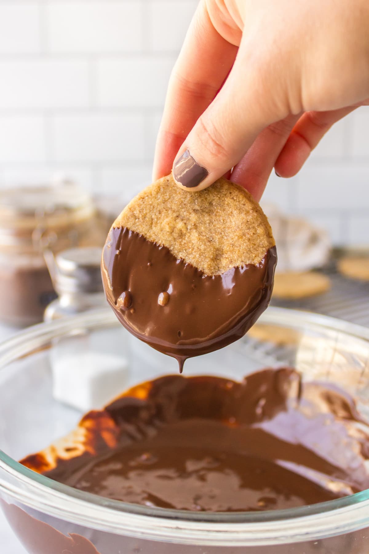 dipping a cookie in chocolate