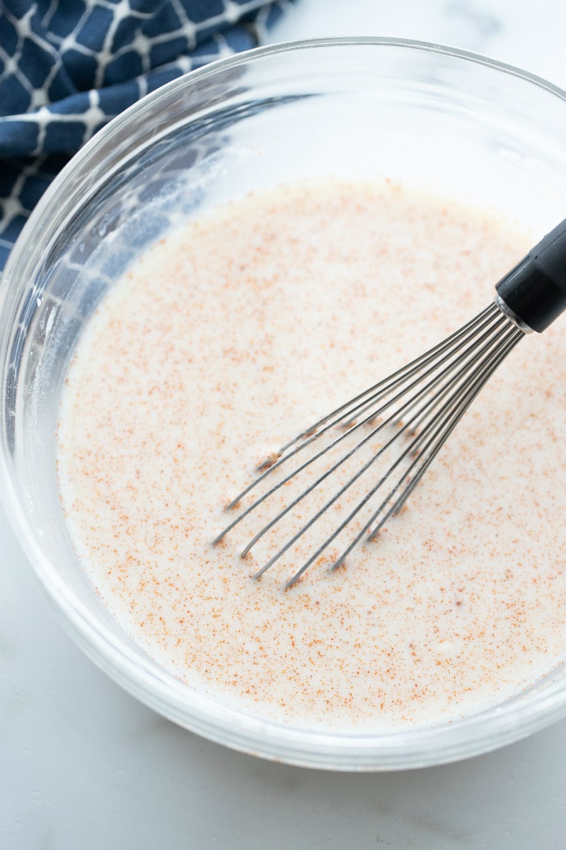 process of making mexican turkey soup whisking in bowl