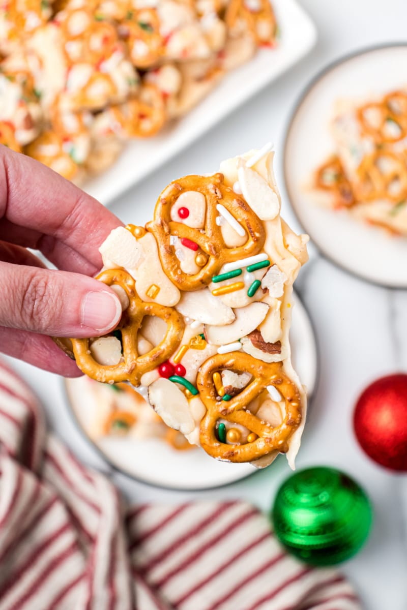 hand holding eggnog pretzel bark