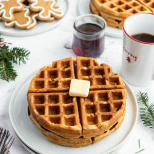 gingerbread waffles on white plate with butter