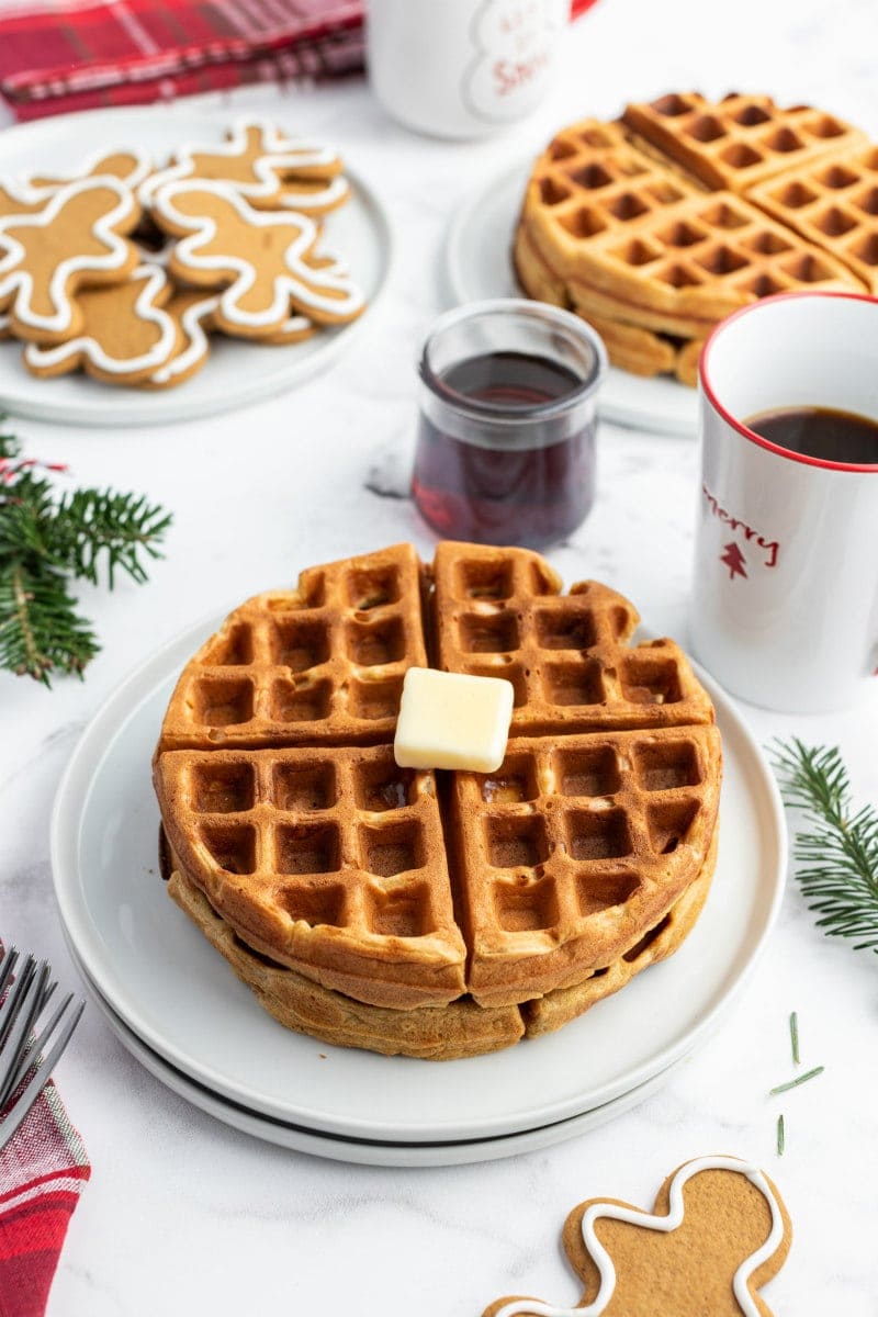 gingerbread waffles on white plate with butter