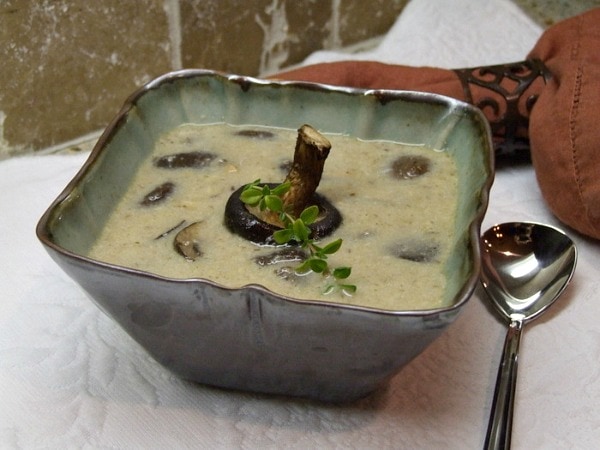 oven roasted mushroom soup in a bowl with a whole mushroom garnish