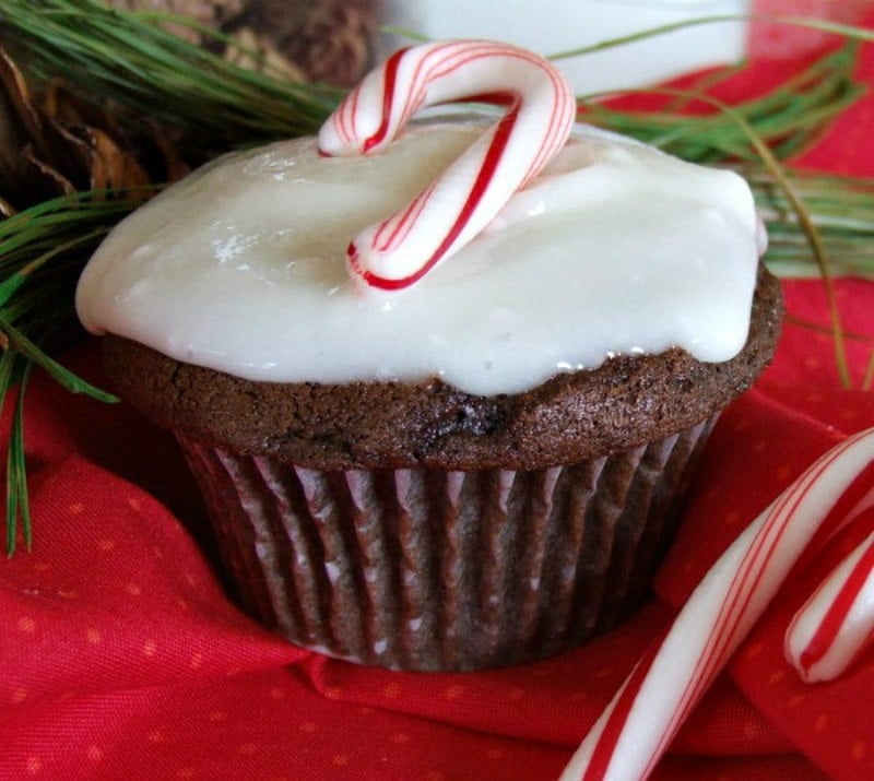 chocolate cupcakes with peppermint icing and a candy cane on top