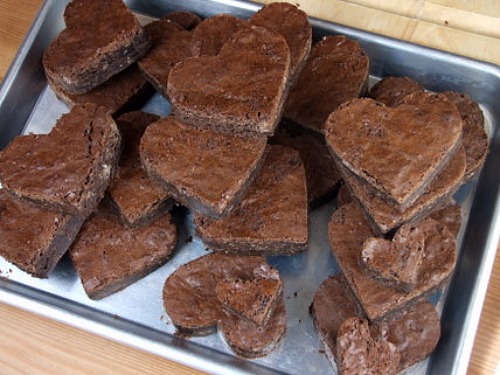 Chocolate Brownie Hearts stacked on a baking sheet