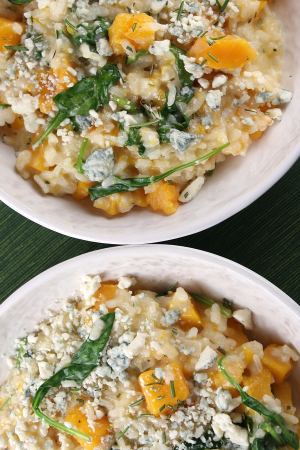 Two bowls of Butternut Squash Risotto with Rosemary and Blue Cheese in two white bowls