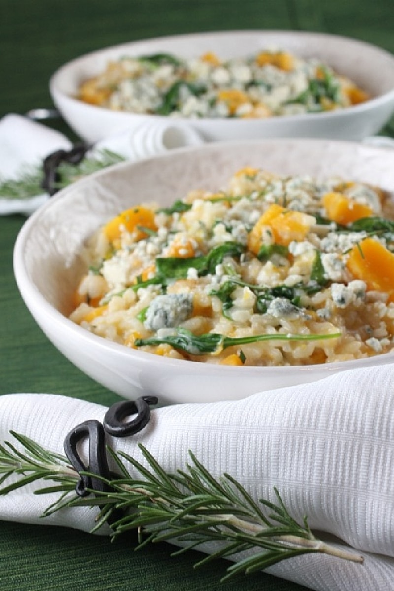 Butternut Squash Risotto with Rosemary and Blue Cheese in white bowls