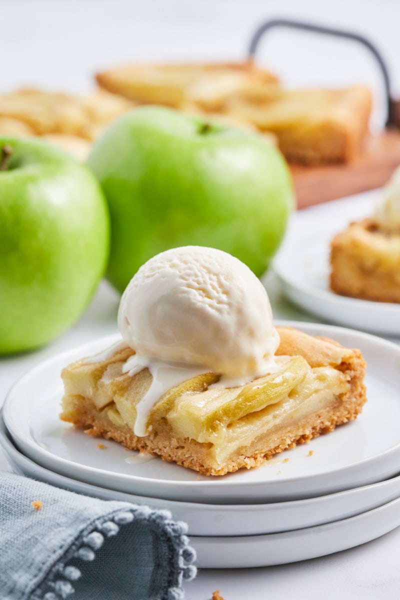 piece of apple tart topped with ice cream on plate