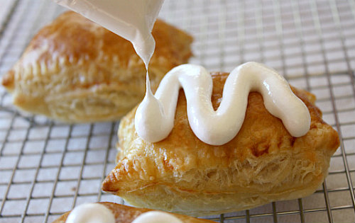 Peanut Butter S'Mores Turnovers drizzled with melted marshmallow