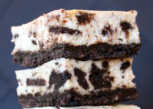 two cookies and cream cheesecake bars stacked on top of each other