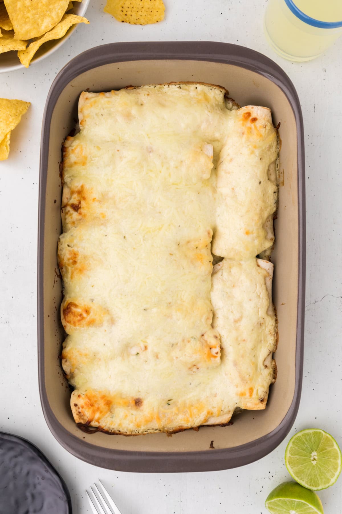 creamy chicken spinach and mushroom enchiladas in pan