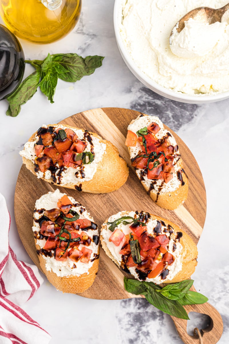 sliced bread with ricotta cheese, tomatoes and balsamic drizzle
