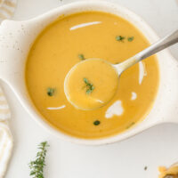 roasted pumpkin bisque in a bowl with a spoon