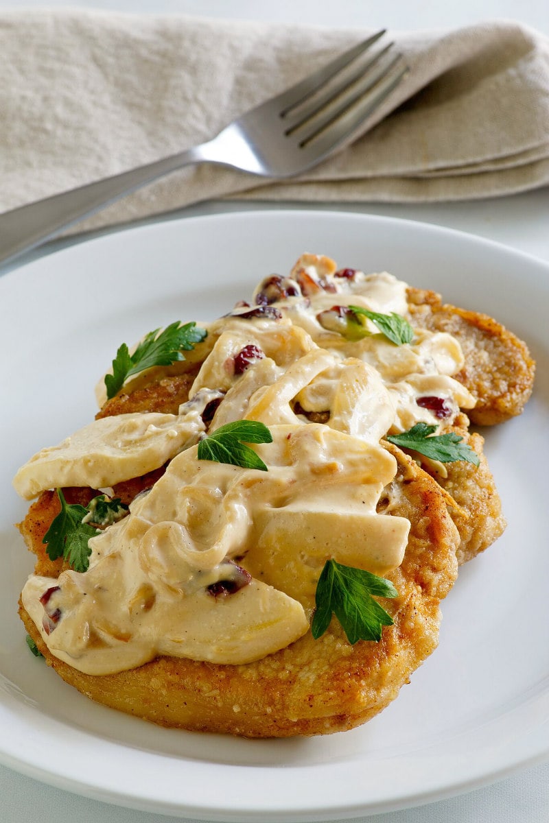 Pork Chops with Creamy Apple Cranberry Sauce recipe from RecipeGirl.com #pork #chops #porkchops #apple #cranberry #sauce #fall #dinner #recipe #RecipeGirl Pork Chops with Creamy Apple Cranberry Sauce
