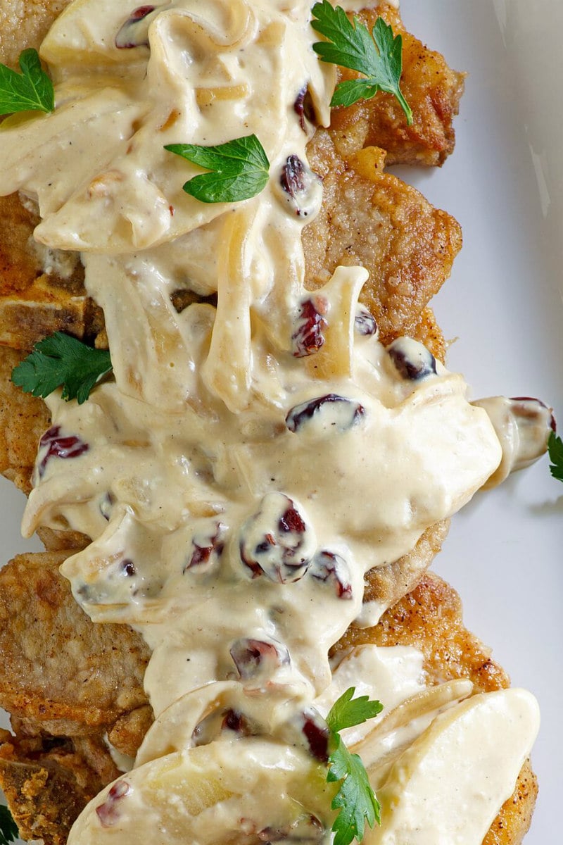 Pork Chops with Creamy Apple Cranberry Sauce recipe from RecipeGirl.com #pork #chops #porkchops #apple #cranberry #sauce #fall #dinner #recipe #RecipeGirl Pork Chops with Creamy Apple Cranberry Sauce