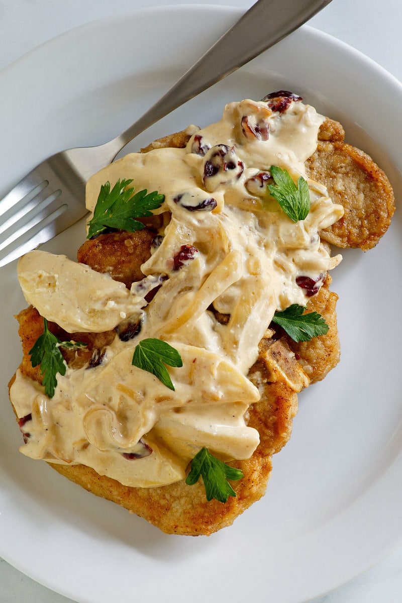 Pork Chops with Creamy Apple Cranberry Sauce recipe from RecipeGirl.com #pork #chops #porkchops #apple #cranberry #sauce #fall #dinner #recipe #RecipeGirl Pork Chops with Creamy Apple Cranberry Sauce