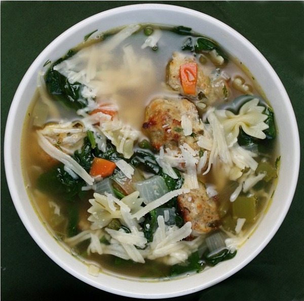 Italian Wedding Soup recipe originally from Ina Garten on RecipeGirl.com #italian #wedding #soup #italianwedding #italianweddingsoup #italiansoup #souprecipe #recipe #ina #garten #inagarten #barefoot #contessa #barefootcontessa #recipe #RecipeGirl Bowl of Italian Wedding Soup