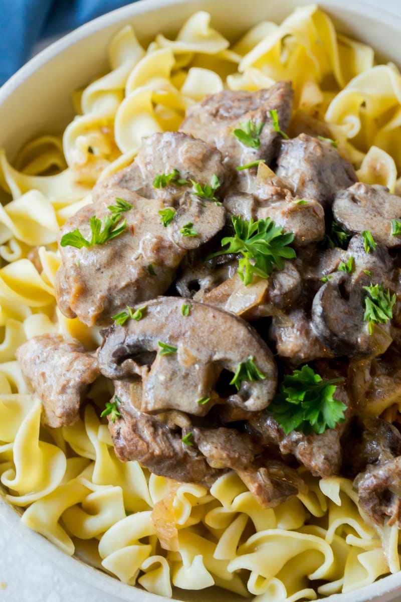 Lightened Up Slow Cooker Beef Stroganoff recipe from RecipeGirl.com #light #weightwatchers #ww #wwfreestyle #slow #cooker #slowcooker #crockpot #beef #stroganoff #recipe #RecipeGirl Slow Cooker Beef Stroganoff served over egg noodles