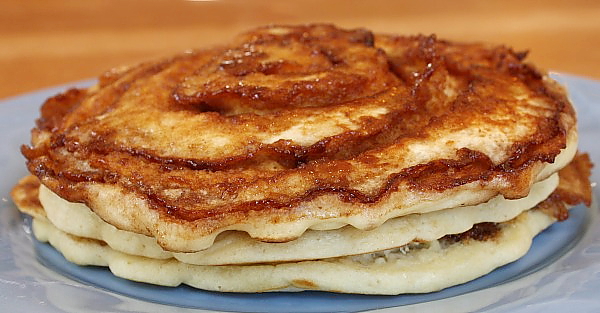 Stack of Cinnamon Roll Pancakes on a blue plate