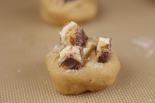 snickers bar on top of cookie dough
