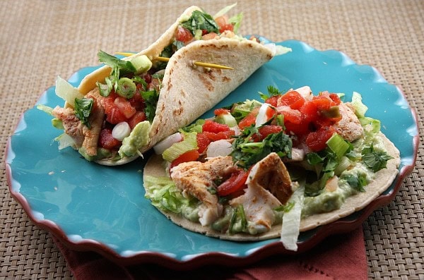 broiled fish tacos on a blue plate