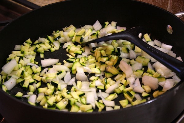 sauteing zucchini and onion in a skillet