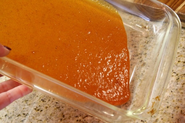 enchilada sauce in a pyrex rectangular casserole dish