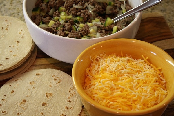 ingredients for beef enchiladas- filling, cheese and flour tortillas