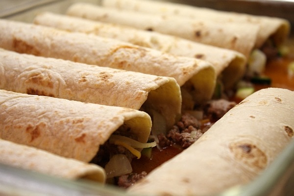 rolled beef enchiladas in a casserole dish