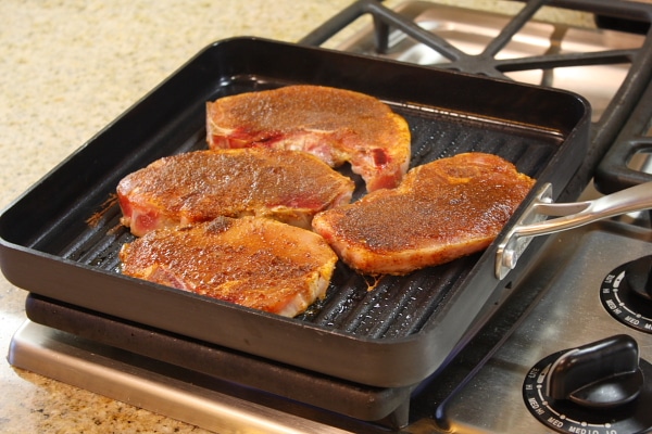 grilling pork chops on a stovetop grill