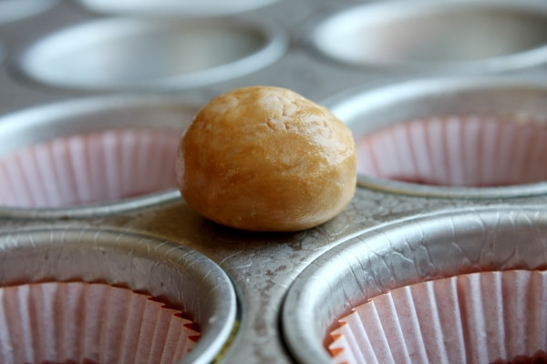 almond butter filling rolled into balls on top of cupcake pan