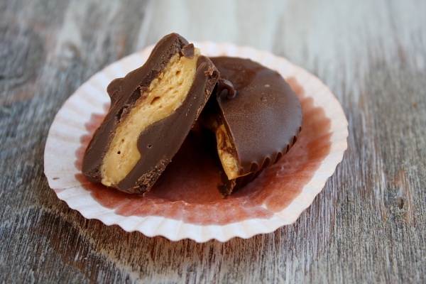 almond butter cup cut in half in paper wrapper