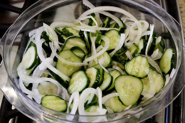 cucumbers and onions in a glass bowl