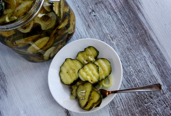 serving of bread and butter pickles in a small white dish