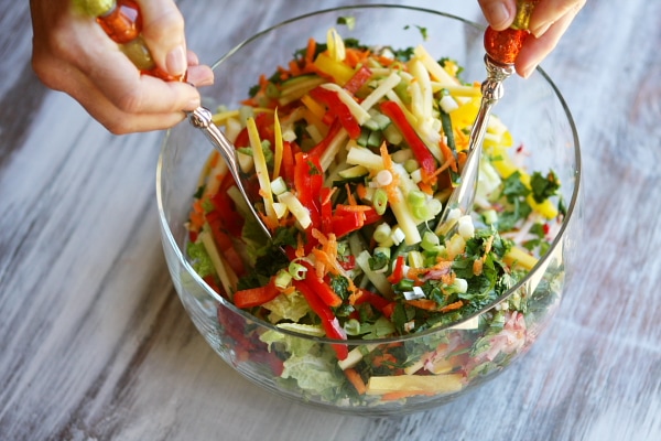 Thai Summer Salad recipe from RecipeGirl.com tossing Thai Summer Salad