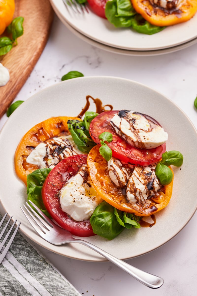 caprese salad with burrata cheese on a white plate