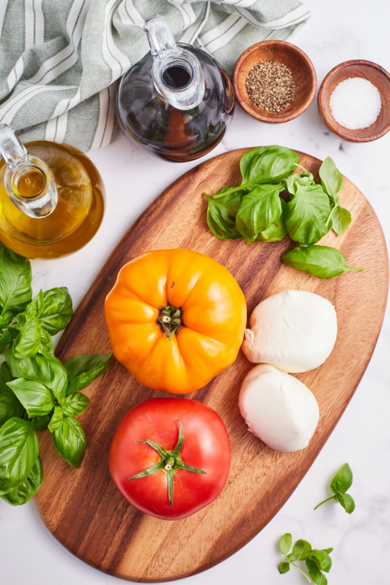 ingredients displayed for making caprese salad with burrata cheese