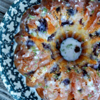 overhead shot of cherry limeade pound cake (from a bundt mold) set on a blue and white patterned cake platter