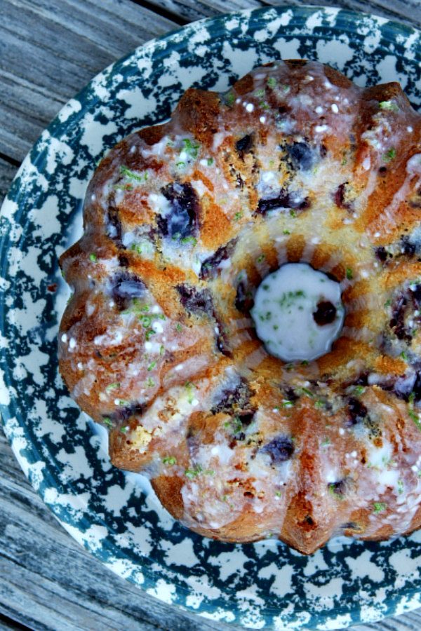 Cherry Limeade Pound Cake made from a bundt pan displayed on a blue and white patterned cake platter