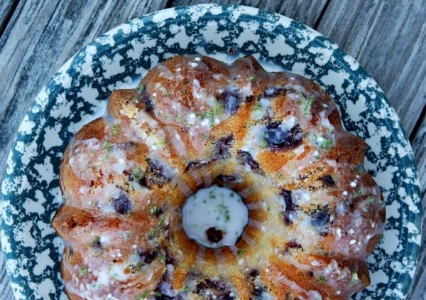 overhead shot of Cherry Limeade Pound Cake from a bundt pan displayed on a blue and white patterned cake platter