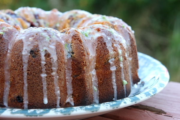 side view of a Cherry Limeade Pound Cake set on a blue and white cake platter