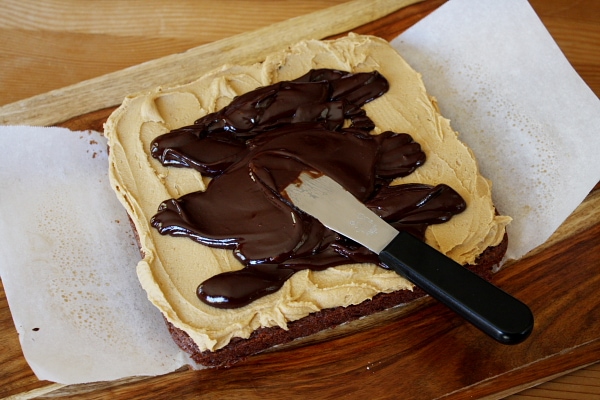 spreading ganache on top of brownies